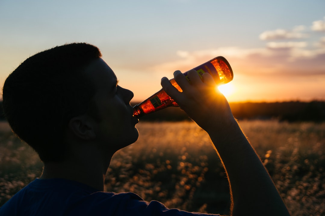 man holding glass bottle