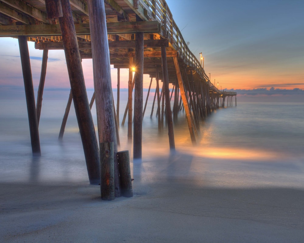 brown wooden dock during sunset