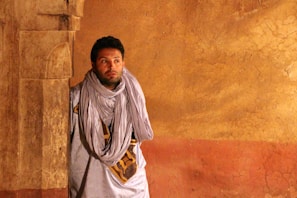 Ravi in a thoughtful pose surrounded by archaeological artifacts, reflecting his academic background.