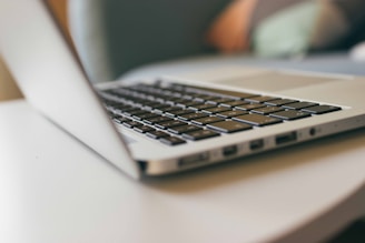 A close-up of a professional laptop on a desk.