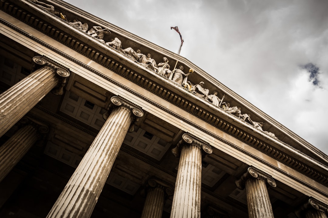 ground-up shot of a white marble federal building on a cloudy day