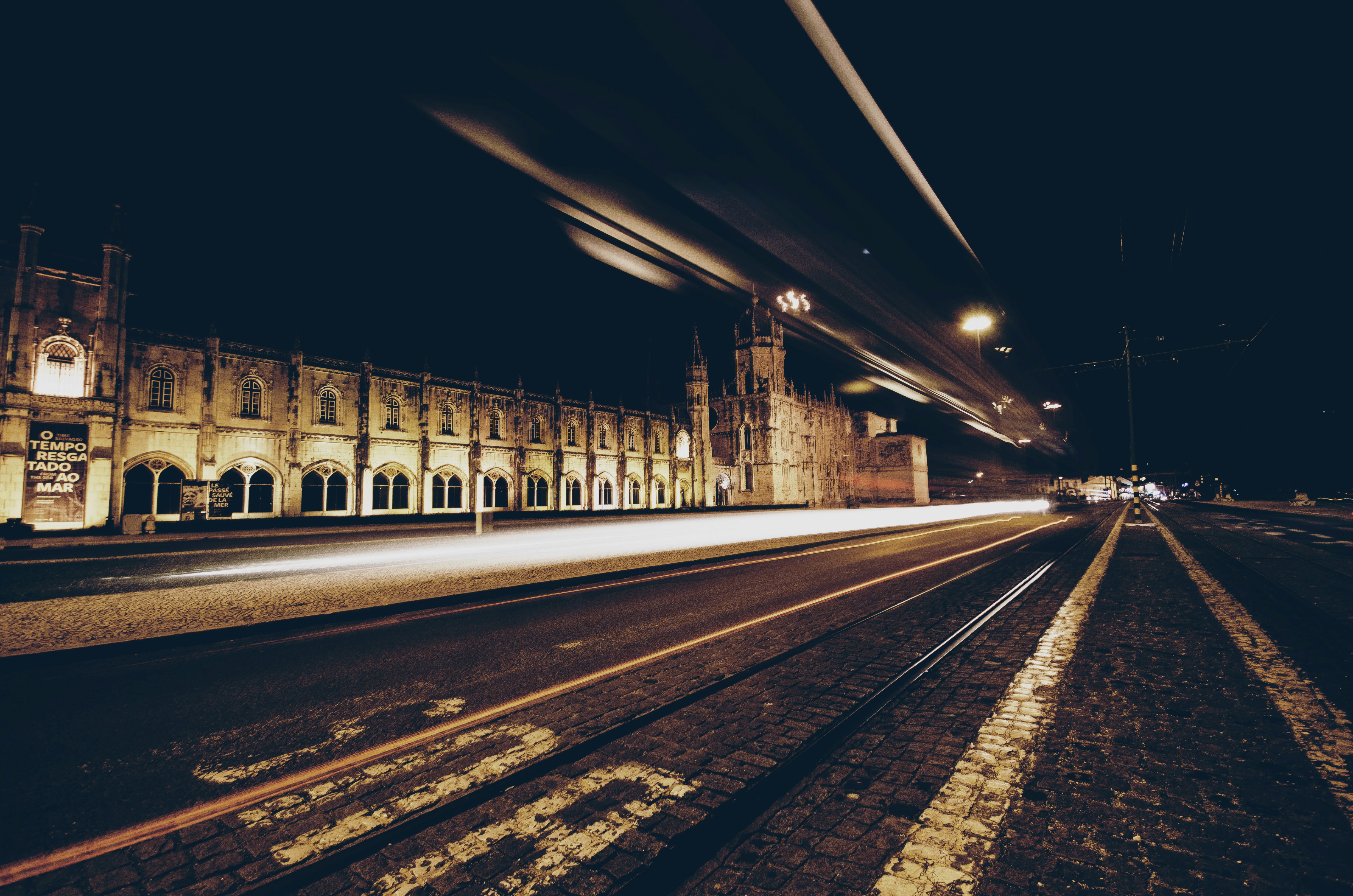 time-lapse photography of passing vehicles on road