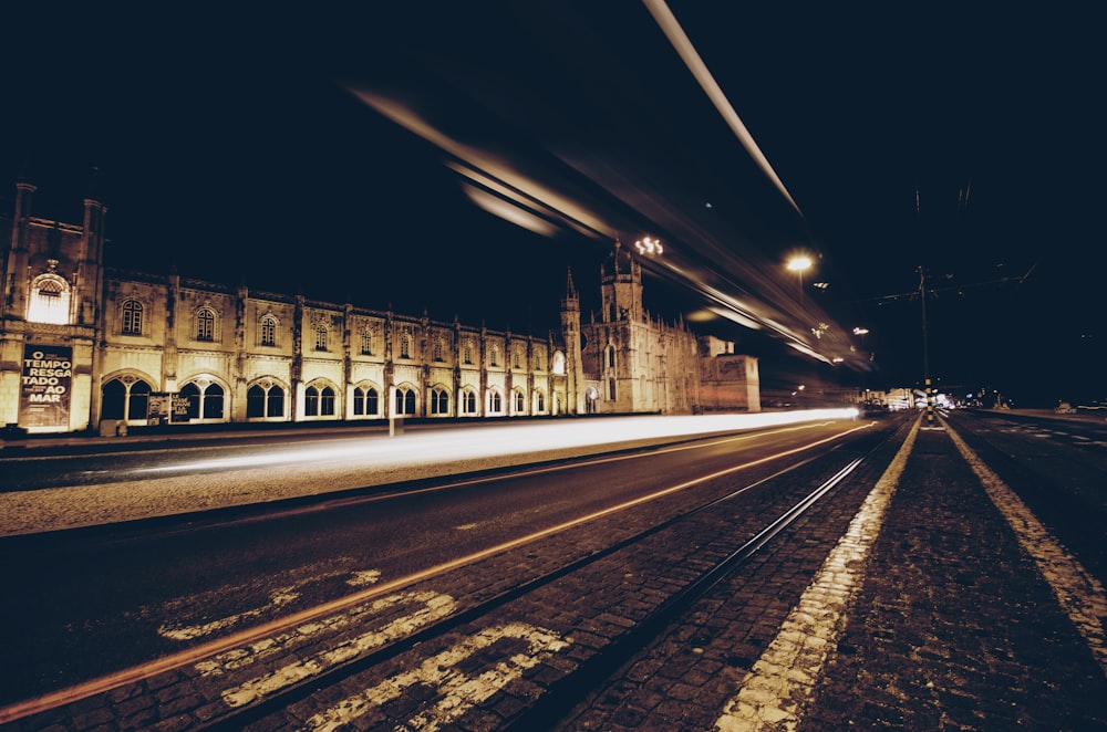 time-lapse photography of passing vehicles on road