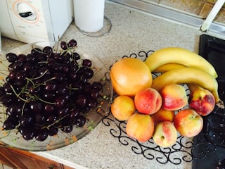 Fresh fruits and vegetables arranged on a kitchen counter.