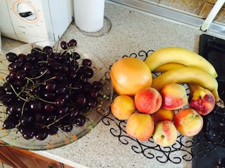 Fresh fruits and vegetables arranged on a kitchen counter.
