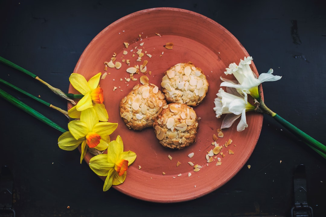 three round cookies on brown plate with petaled flowers