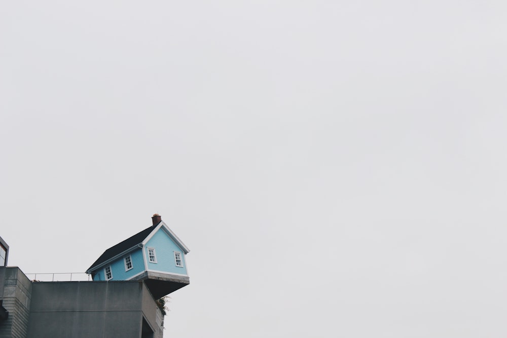 blue concrete storey house on top of building at daytime