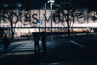 Backlit signage glowing softly on a modern retail shop facade.