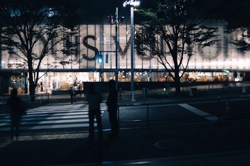 Backlit signage glowing softly on a modern retail shop facade.