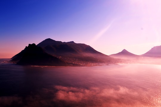 mountain near body of water under blue sky in Hout Bay South Africa