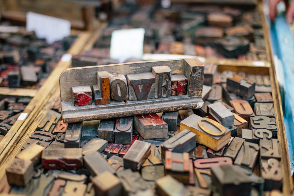 a pile of old wooden typewriters sitting on top of a table