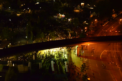 Mobile surveillance trailer overseeing a large outdoor community event with crowds.