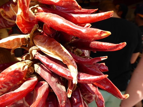 Close-up of vibrant red chili peppers drying under the sun in Kayan region.