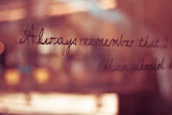Soft-focus shot of a handwritten letter next to a cup of coffee, evoking intimacy and warmth.
