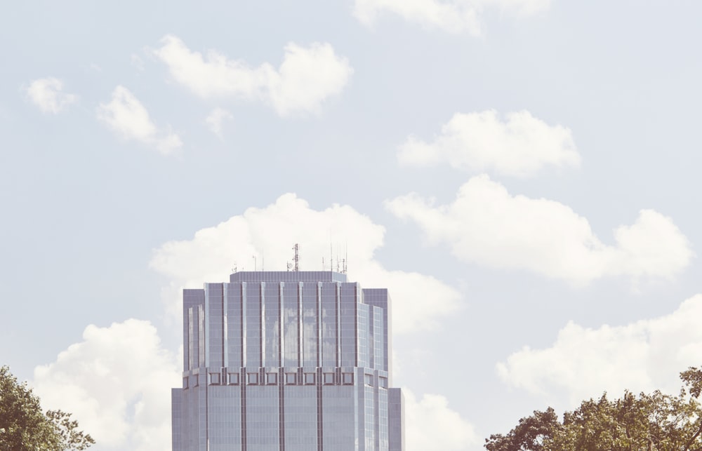 photography of high-rise building with clouds