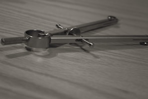 Close-up of hands working on a geometric construction using a compass and ruler.