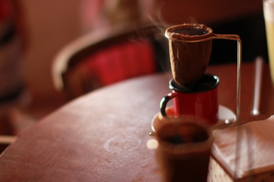 A warm, rustic coffee setup with traditional Mexican textiles and a steaming cup of artisan coffee.