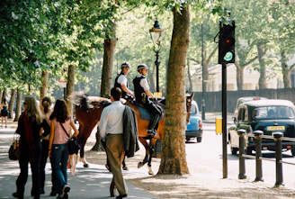 Police officers patrolling a busy city square during the day.