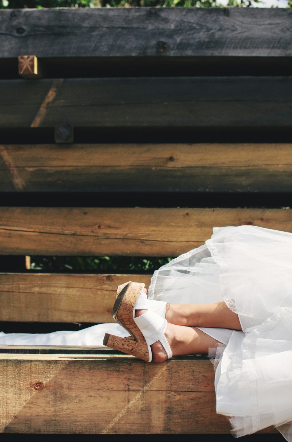 person wearing brown-and-white chunky heels during daytime