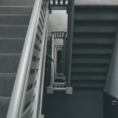photo of grey staircase with grey metal railings