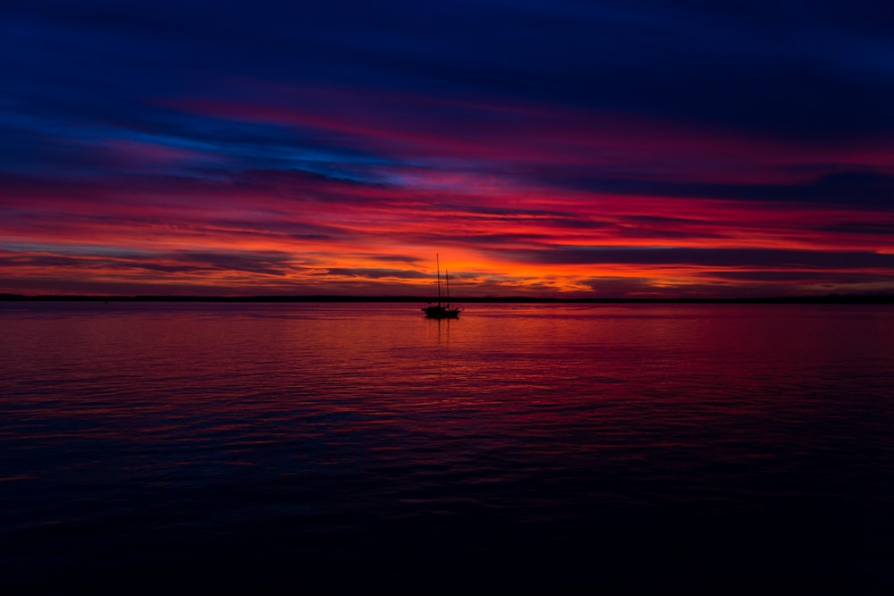 boat on body of water during golden time