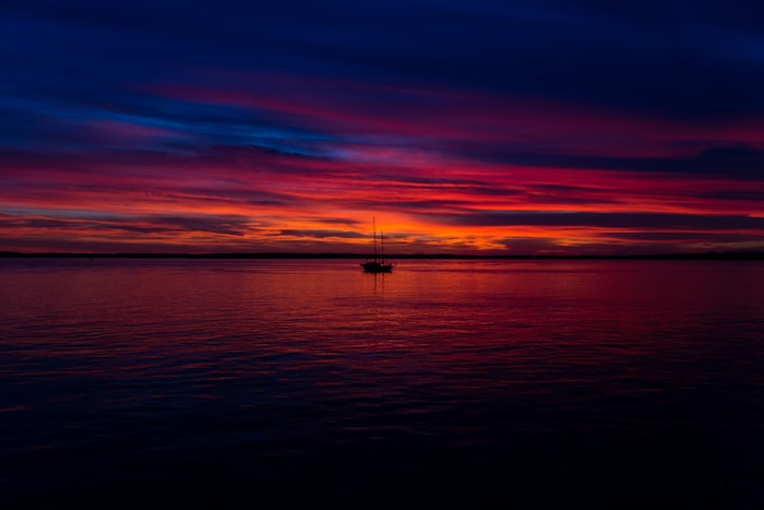 Silhouette of boat on sea at sunset