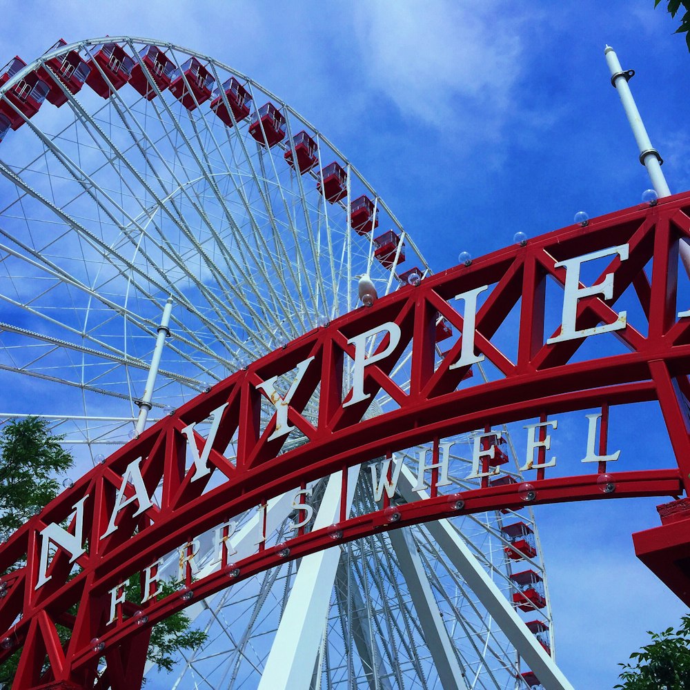 Grande roue rouge et blanche sous le ciel bleu pendant la journée