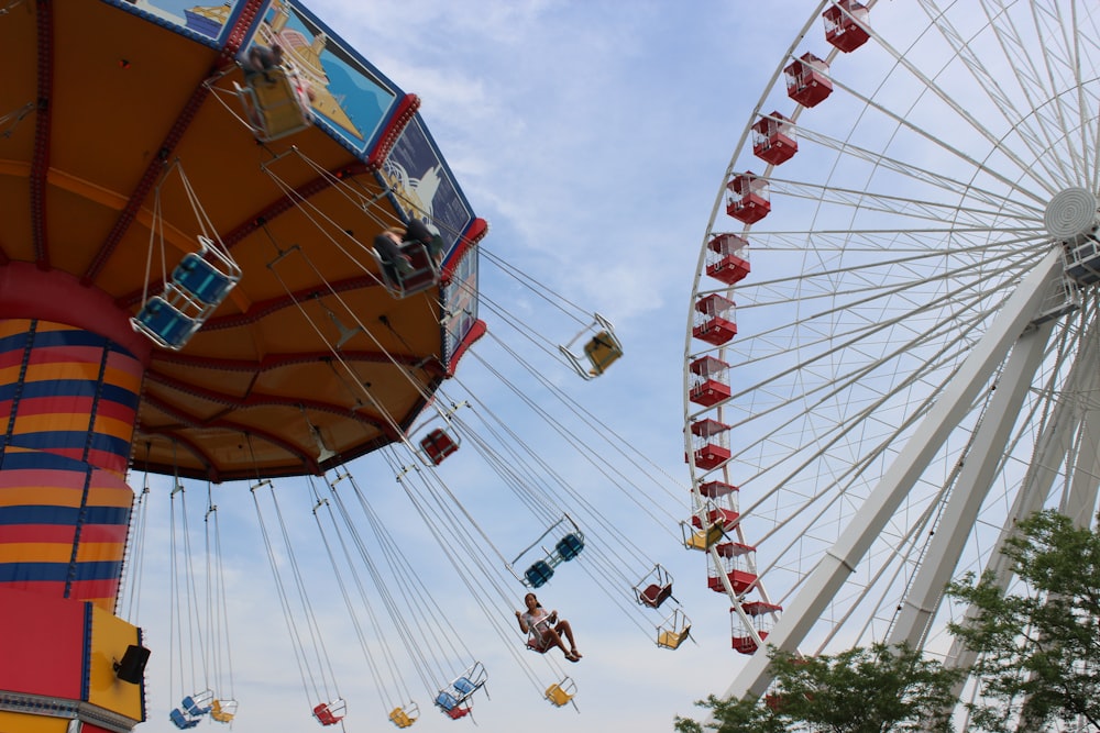 people riding on amusement park ride during daytime