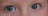 Close-up of a smiling woman wearing clear contact lenses, highlighting her bright eyes.