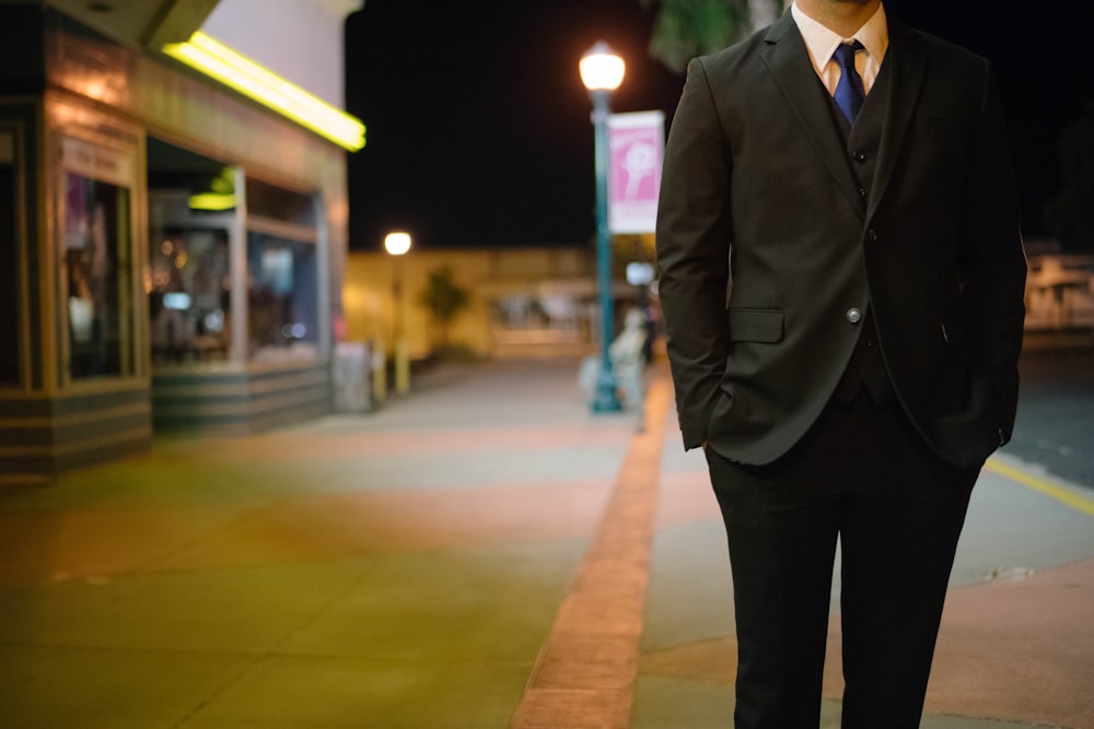 man walking on standing putting is hands inside pocket