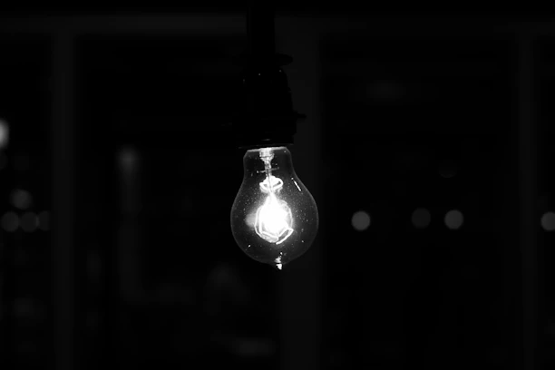 A glowing light bulb illuminating a dark background, symbolizing bright ideas.