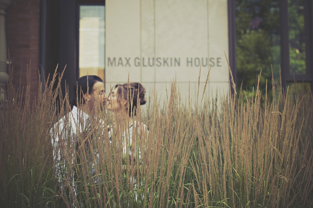 woman and man kissing near Max Gluskin House building