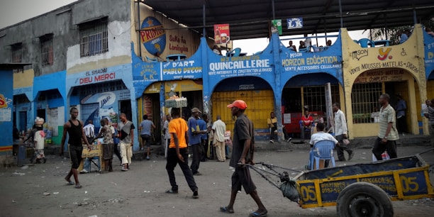 A bustling local street with shops and people interacting.