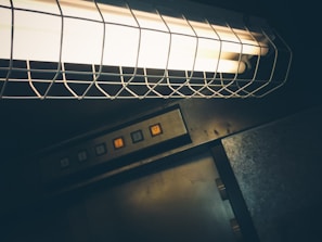 Modern elevator control buttons illuminated with a soft glow in a minimalist setting