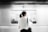 woman in white elbow-sleeved shirt standing near white train in subway