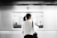 woman in white elbow-sleeved shirt standing near white train in subway