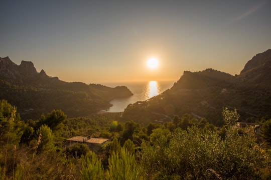 green mountain near body of water during golden hour in Mallorca Spain