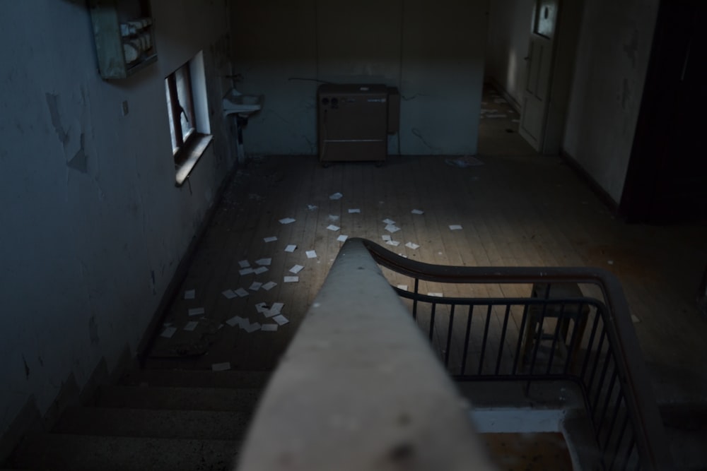 closeup photo of concrete stair surrounded by white painted wall