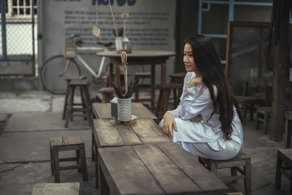 woman gray dress sitting on chair near table