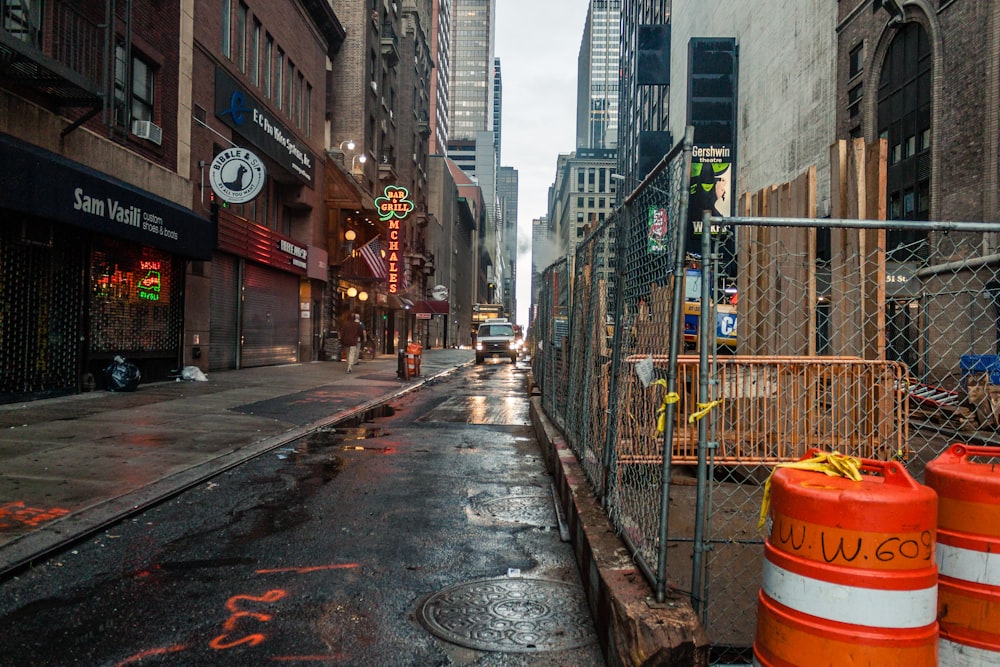 gray concrete road between buildings during daytime