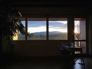 Writing desk by the window in standard room with a scenic view.