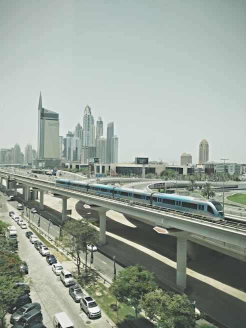 An urban metro train gliding through a modern cityscape.