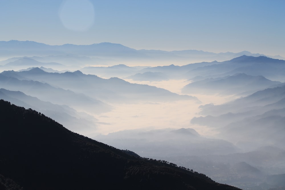 aerial photography of mountain range covered in clouds at daytime