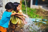 two girl playing water