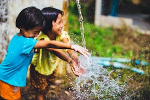 two girl playing water