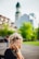 person covering face with hands outdoors