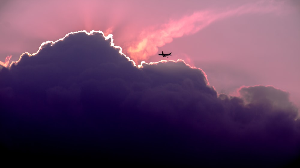 silhouette of airplanes of white clouds