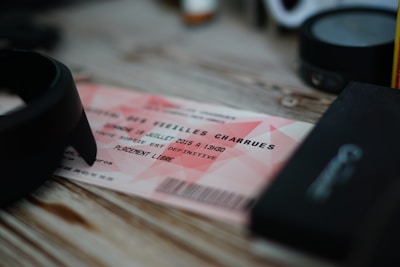 Close-up of a ticket with fullysyde records logo, resting on a wooden table.