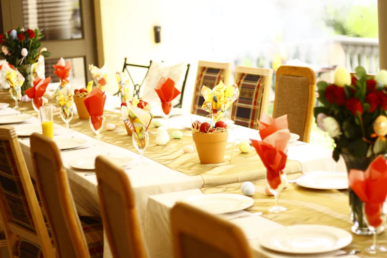 A beautifully arranged table set for a festive celebration with colorful decorations and elegant tableware.