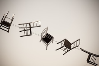 five brown wooden chairs bound in line as a theme